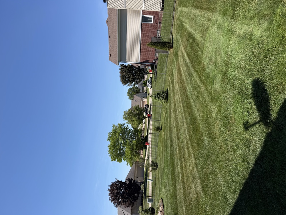 A striped, well-maintained lawn representative of Summit's work across Macomb County